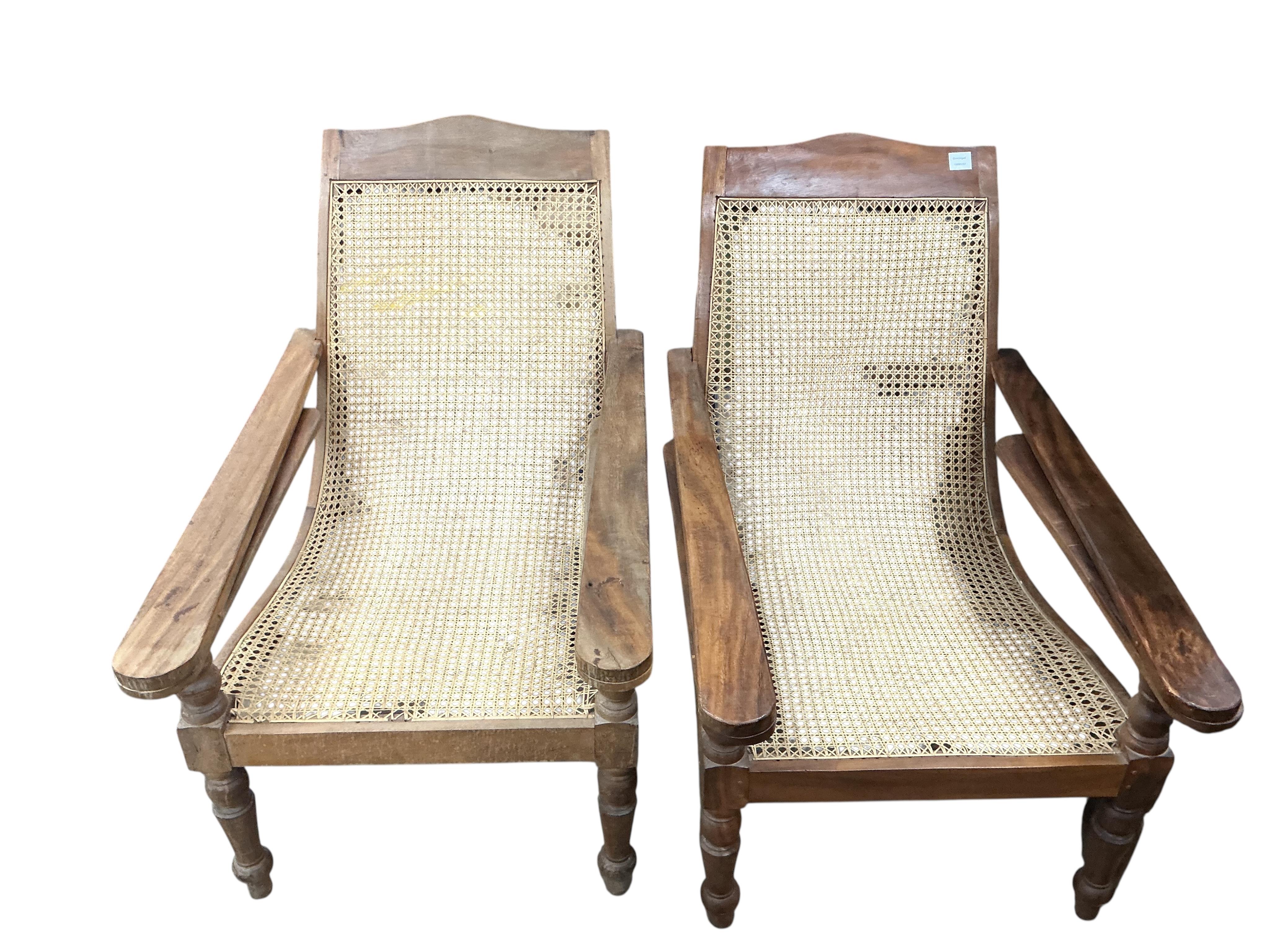 A pair of caned hardwood plantation armchairs, width 66cm, depth 105cm, height 90cm